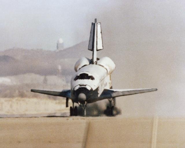 The Space Shuttle Columbia touches down on lakebed runway 23 at Edwards Air Force Base, Calif., to conclude the first orbital shuttle mission
