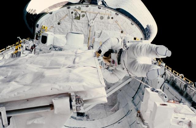 Astronaut Kathryn Sullivan checks SIR-B antenna during EVA