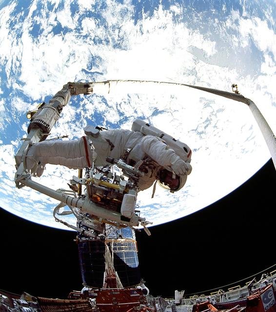 Astronaut Jeffrey Hoffman on RMS during third of five HST EVAs