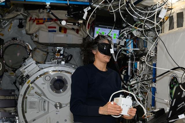 Astronaut Suni Williams wears a virtual reality headset during spacewalk training