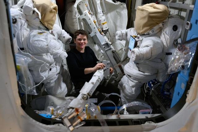 Astronaut Anne McClain works inside the Quest airlock assembling spacewalk hardware