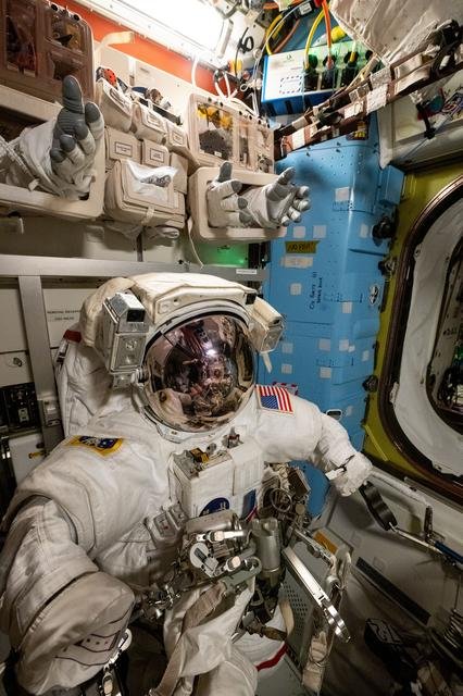 A spacesuit is pictured staged inside the Quest airlock