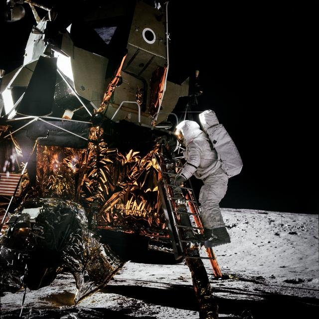 Apollo 12 Mission image - Dark view of Astronaut Alan L. Bean climbing down the ladder of the Lunar Module (LM)