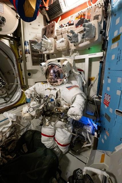 A spacesuit is pictured staged inside the Quest airlock